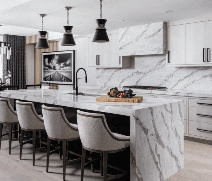 Modern kitchen with a waterfall-edge featuring Pompeii Quartz Serenata/ Vicostone Quartz Amarcord countertop and sleek black fixtures.