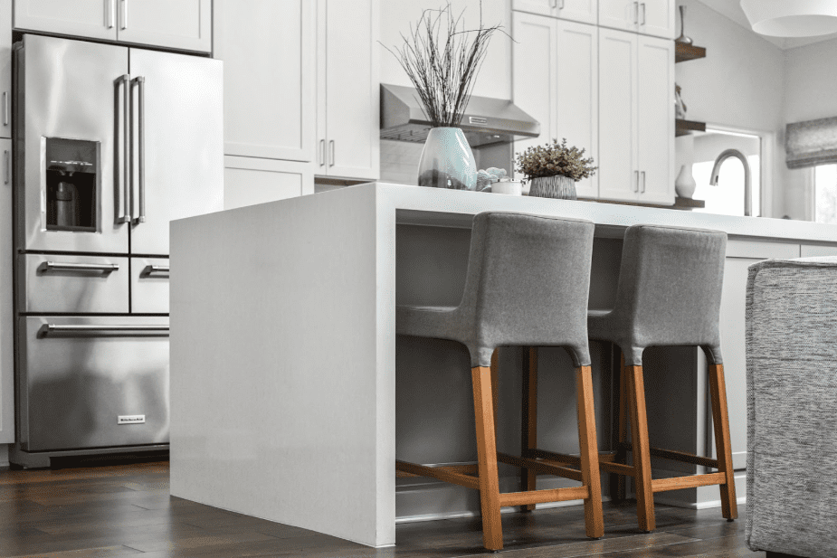 Modern kitchen with Pompeii Quartz Avorio/ Vicostone Quartz Bella Blanco waterfall island.
