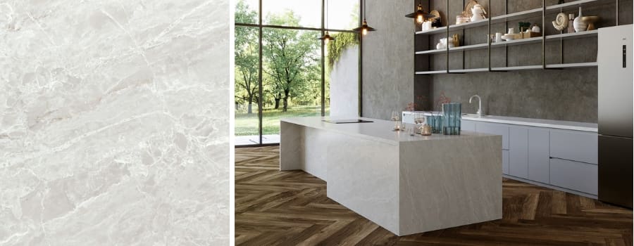 Cassandra Quartz slab close-up with soft alabaster tones and golden veining, shown on a modern waterfall kitchen island with wood floors and floor-to-ceiling windows.