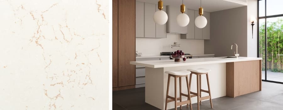 Golden Polaris Quartz slab with soft white background and fine golden veining, showcased on a modern kitchen island with wood accents, pendant lighting, and contemporary cabinetry.
