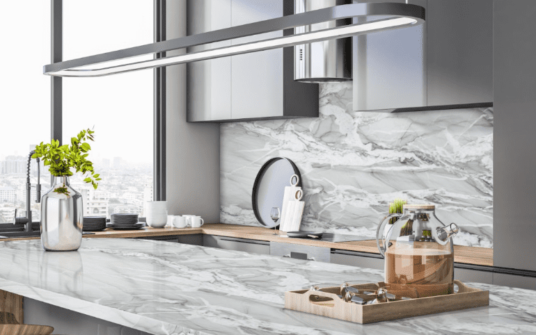 Sleek kitchen with Gucci Extra Quartzite countertops and backsplash, modern cabinets, and large windows with city views.