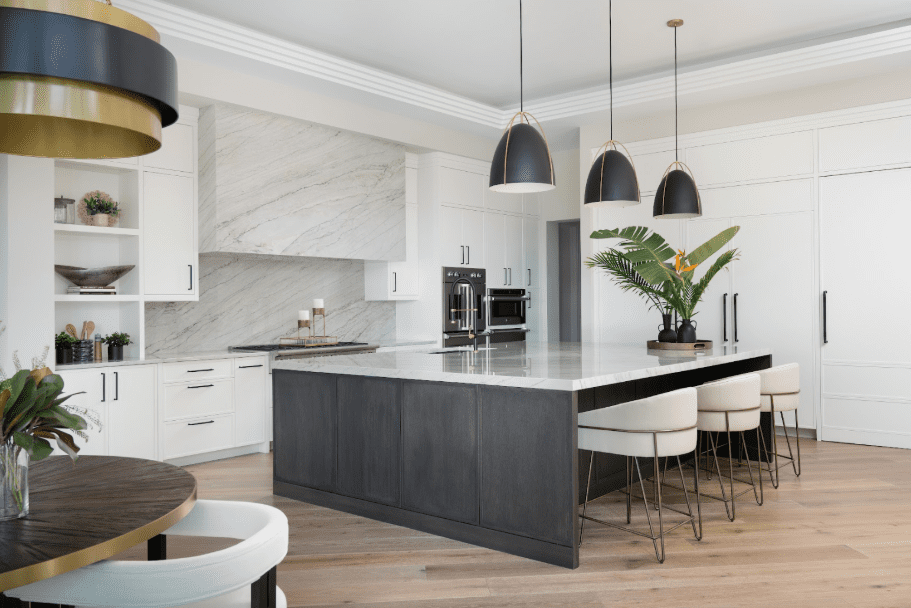 A kitchen with Bianca quartzite with a sleek white and black color scheme.