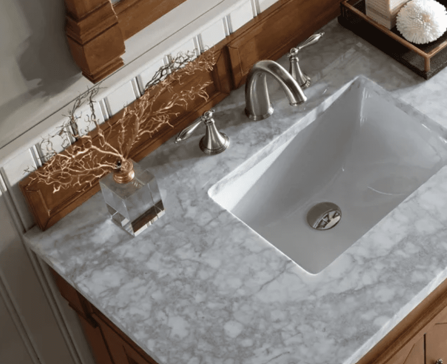 Carrara Marble countertop surrounding a sink in a bathroom.