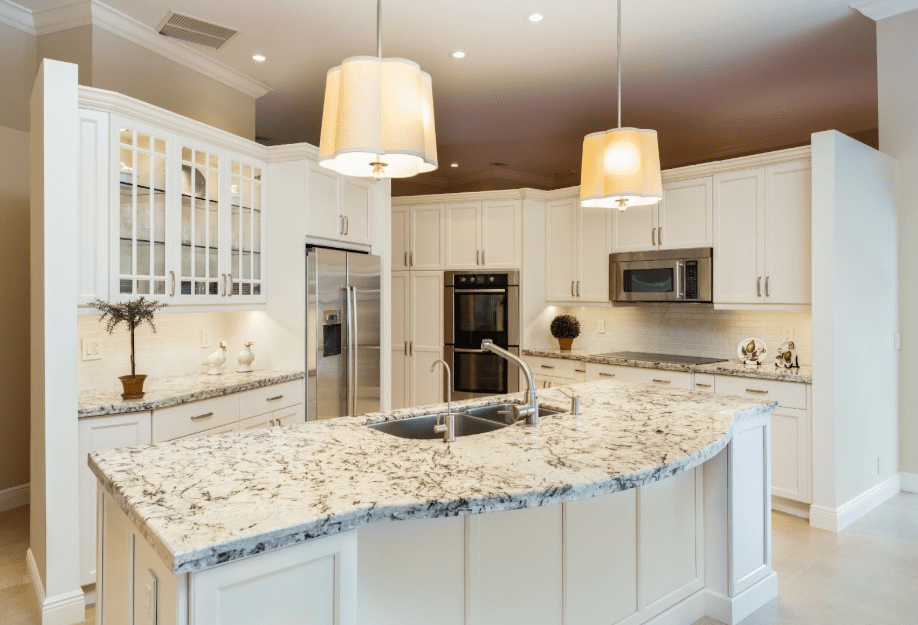 A high-top bar with a light toned granite, Juperana Delicatus, and a matching perimeter countertop.