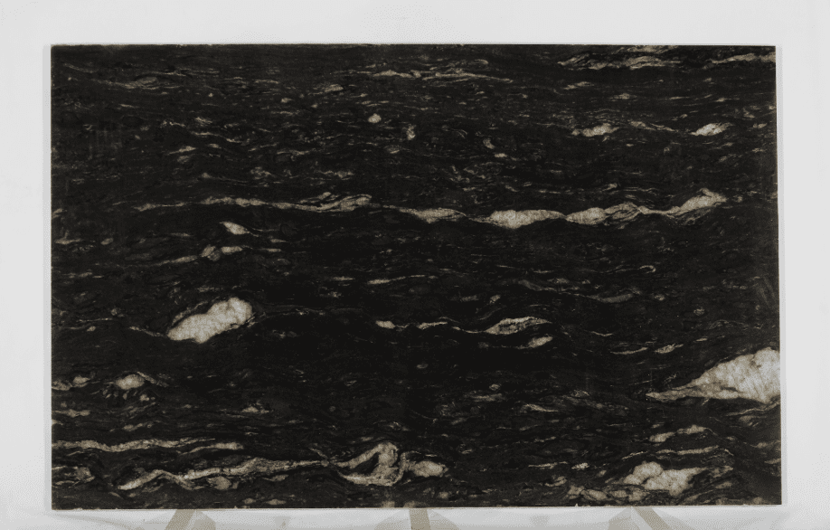 Black Cosmic granite slab with deep black tones and flowing white and gold veining.