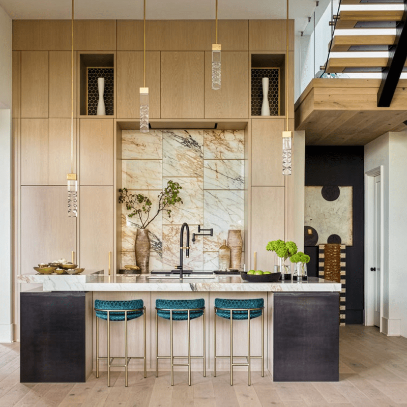 Luxury kitchen with real Calacatta Gold Macchia Vecchia marble countertops and backsplash, paired with warm wood cabinetry and modern accents.