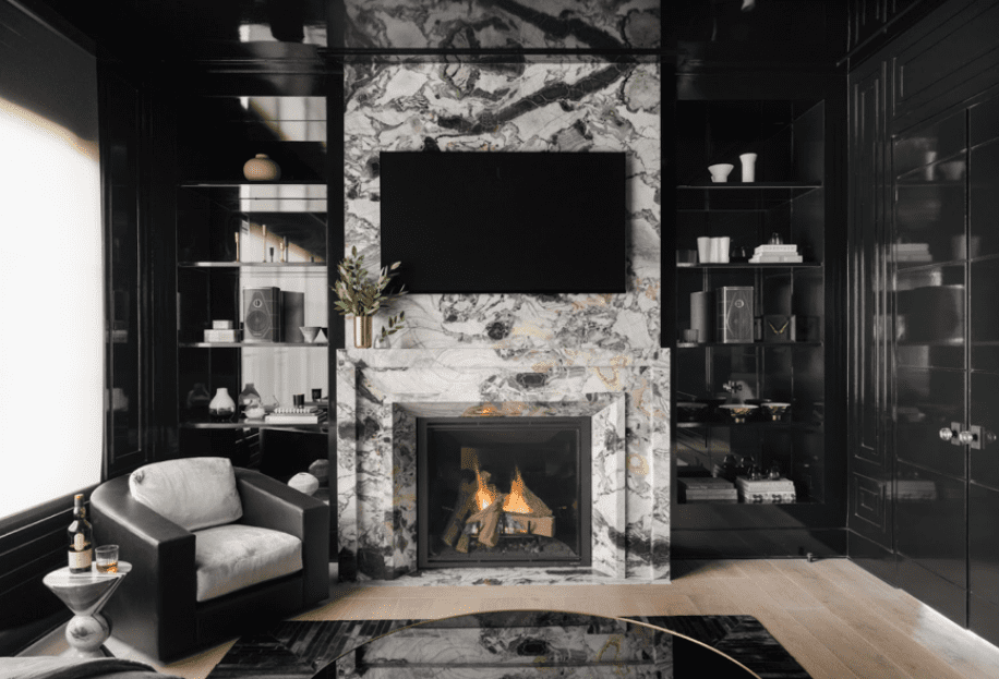 An image of a beautiful white and black marble fireplace in a living room. 