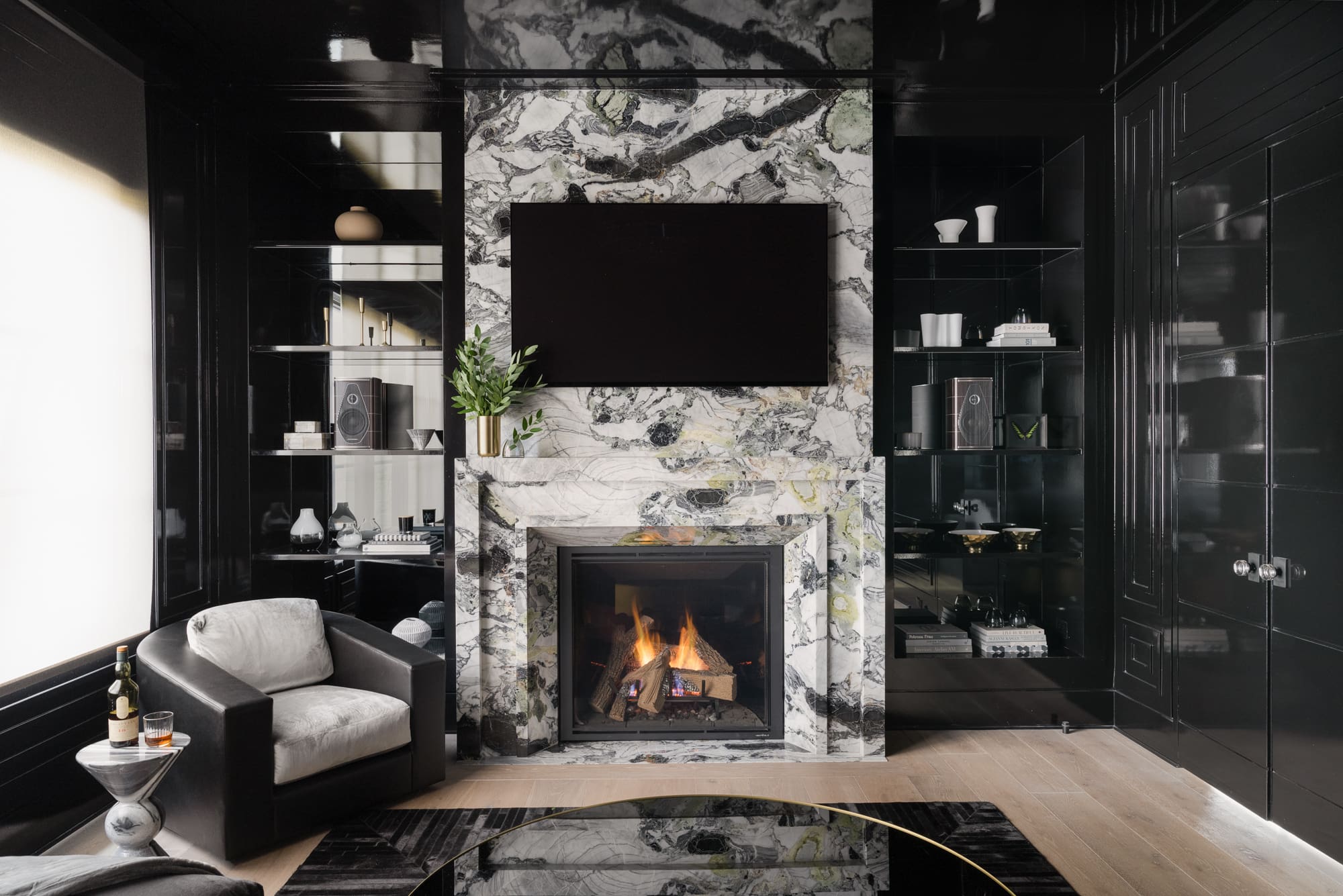 Living room fireplace surround featuring striking marble veining used in faux marble vs real marble comparisons.
