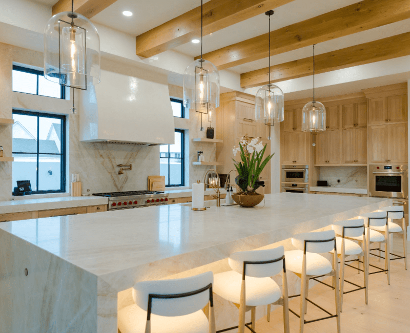 Modern kitchen with Taj Mahal quartzite countertop island featuring subtle taupeveining.
