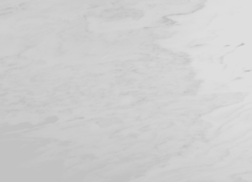 Danby marble surface with soft gray veining on a white background.
