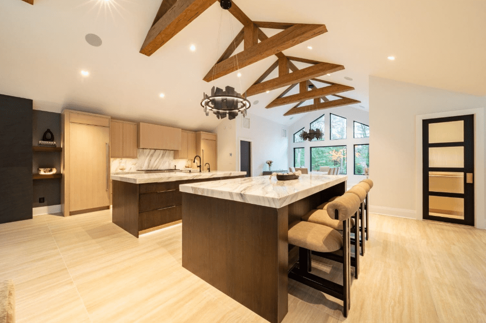 Bright kitchen with white marble countertops and island in a modern rustic design.