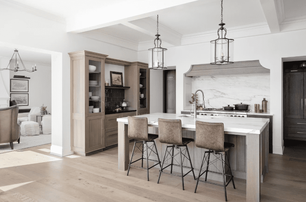 Elegant kitchen with white marble island and backsplash in a neutral-toned interior.