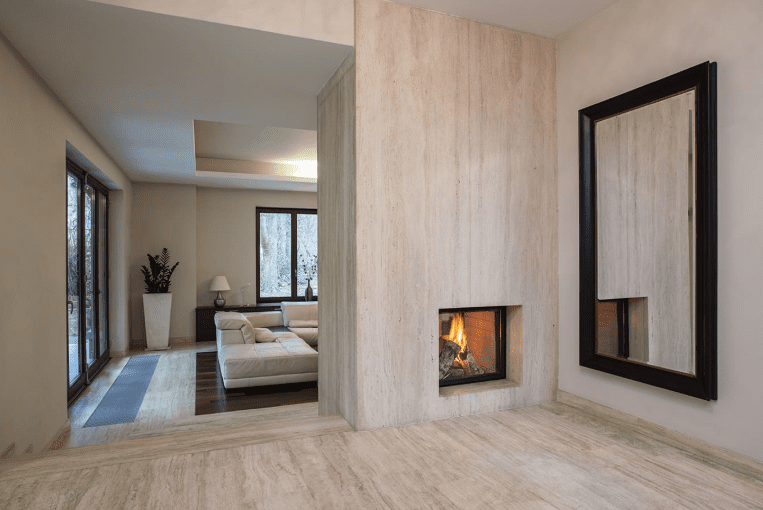 Full-height stone column with built-in fireplace dividing an open interior space.
Travertine - UMI Stone 
