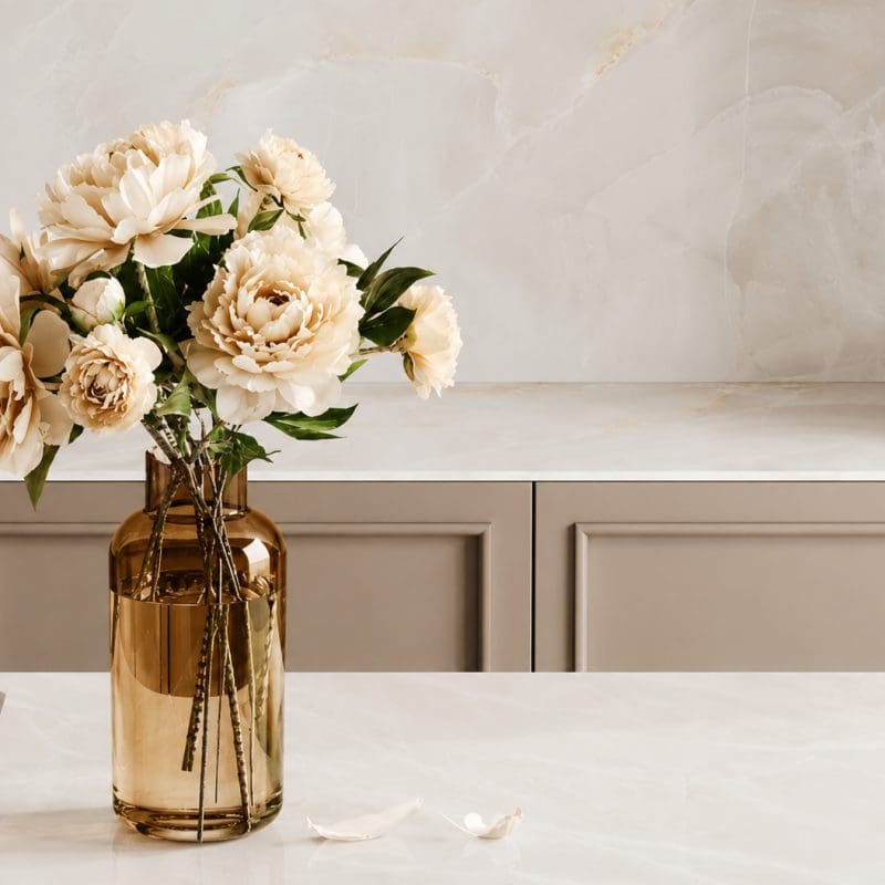 Porcelain countertops and backsplash with soft beige veining.