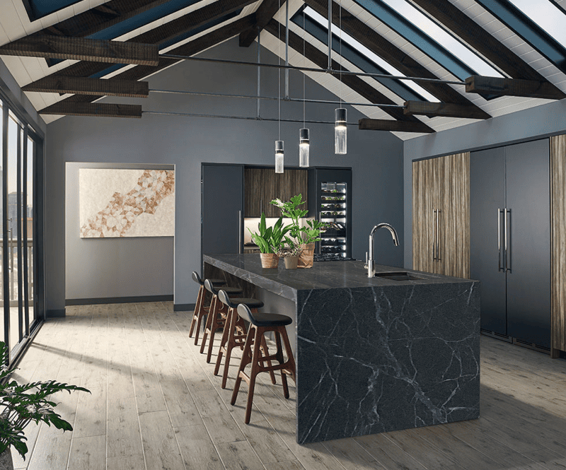 Dark soapstone countertops with white veining in a modern kitchen.