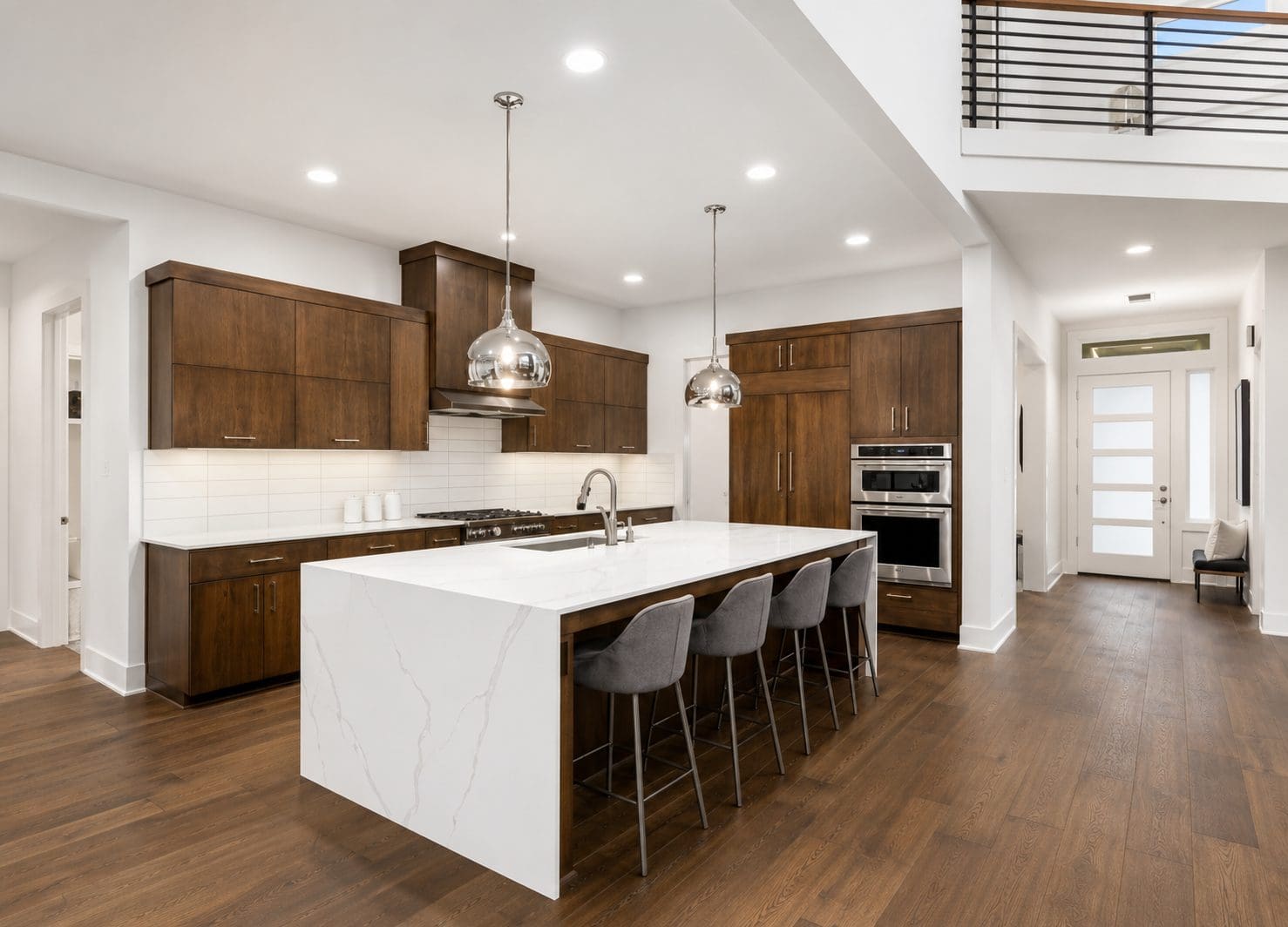 Modern kitchen featuring Calacatta Classico quartz countertops and a waterfall island.
