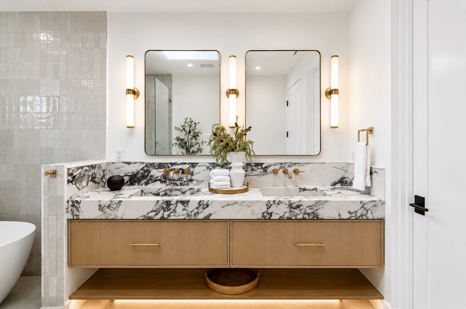 Modern bathroom vanity with dramatic white marble featuring bold gray veining. 