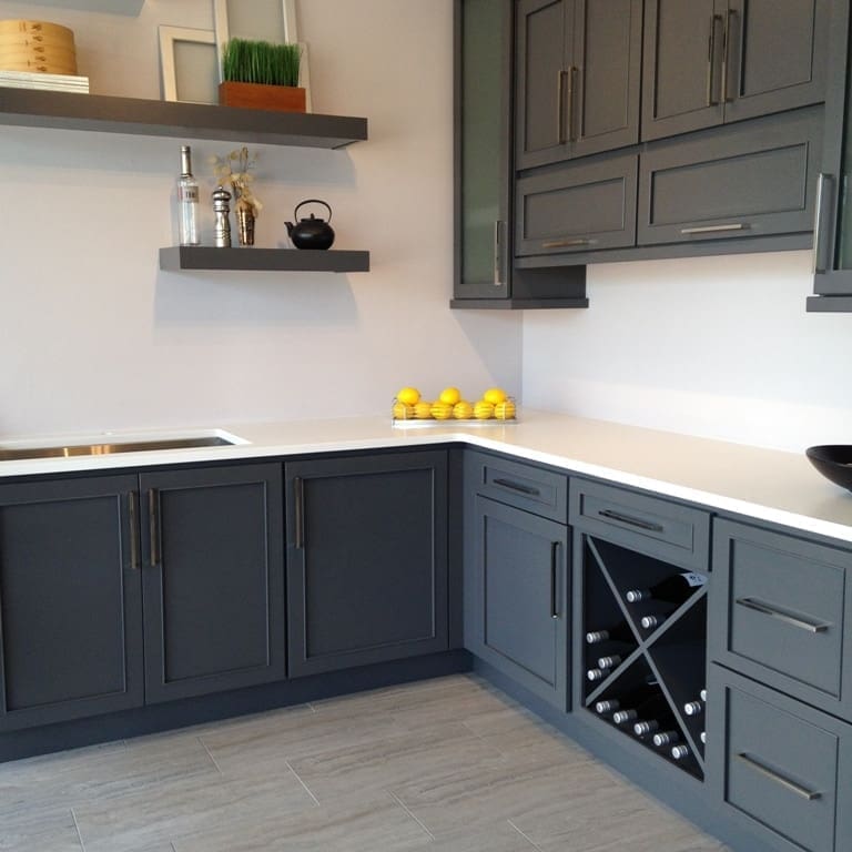 Modern kitchen with white quartz countertops and dark gray cabinetry.