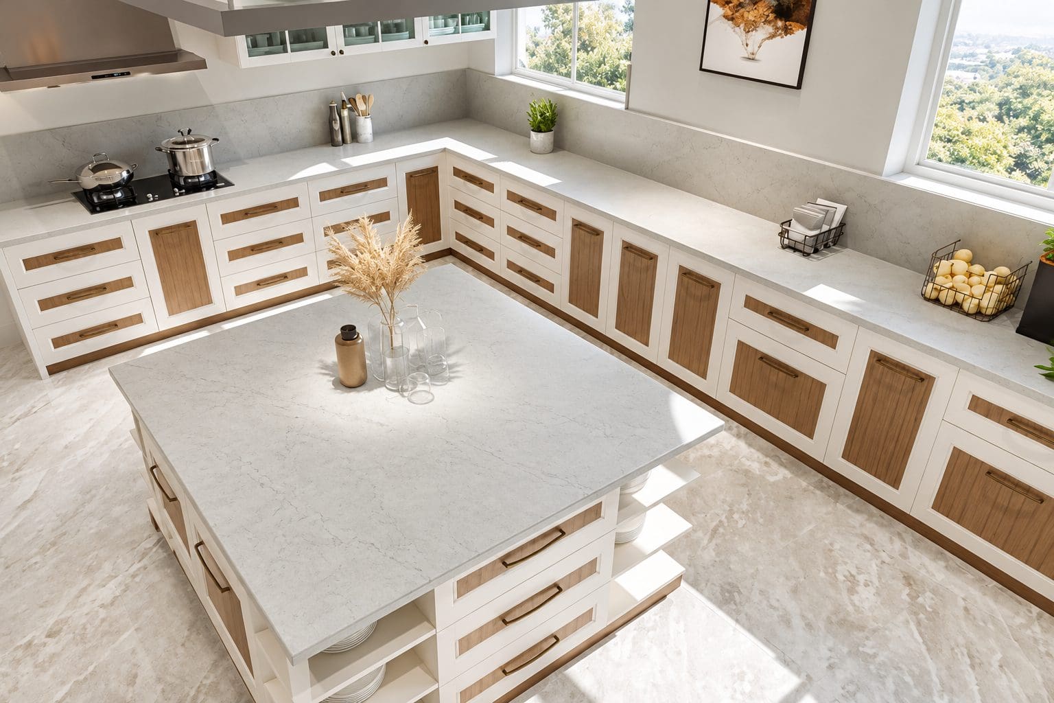 Overhead view of a white kitchen island and countertops in quartz with wood-accented cabinetry. 